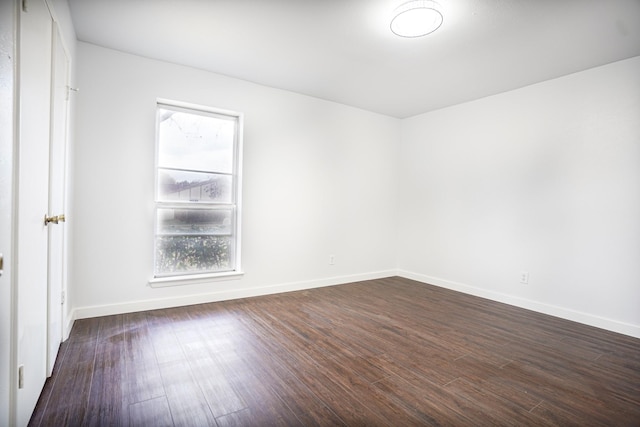 spare room featuring dark hardwood / wood-style flooring