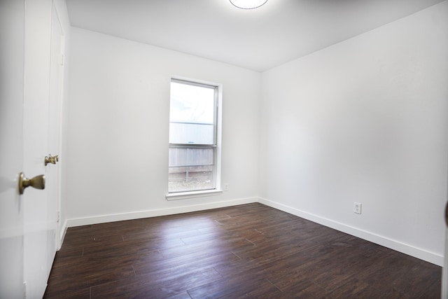 empty room with dark wood-type flooring