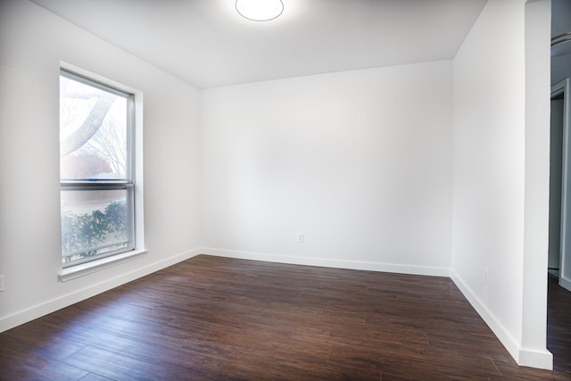 spare room featuring dark hardwood / wood-style flooring