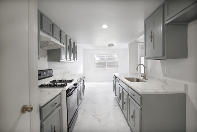 kitchen with gray cabinets, white range with gas cooktop, and sink