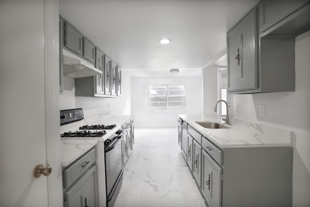 kitchen with sink, gray cabinets, and gas stove