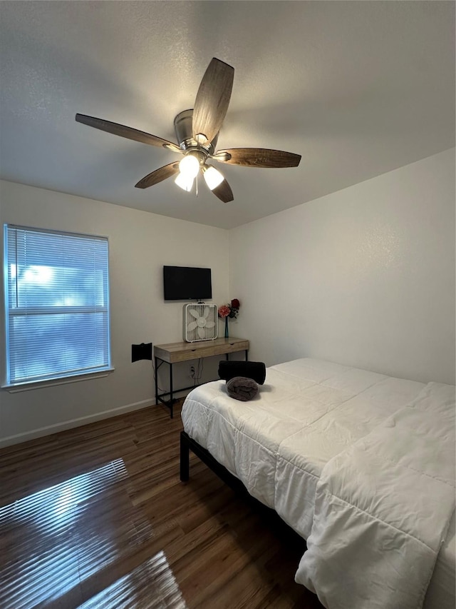 bedroom featuring dark hardwood / wood-style flooring and ceiling fan