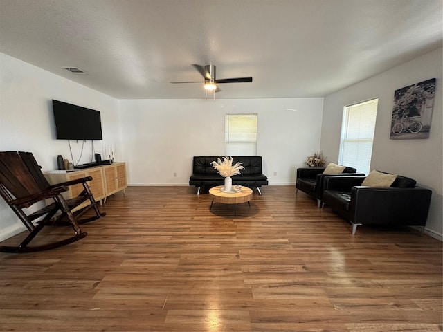 living room featuring ceiling fan, plenty of natural light, and hardwood / wood-style floors