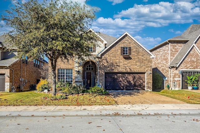 view of front of house with a garage and central air condition unit