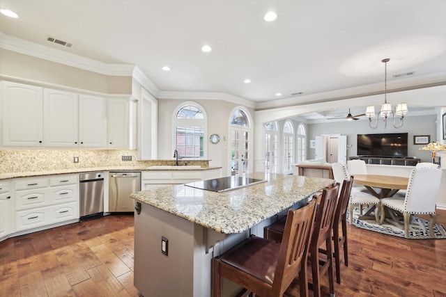 kitchen featuring white cabinetry, sink, dark hardwood / wood-style floors, pendant lighting, and black electric cooktop