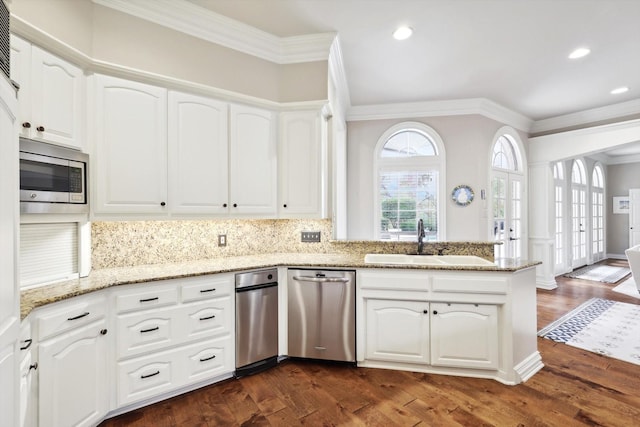 kitchen featuring white cabinets, stainless steel microwave, dark wood-type flooring, and sink