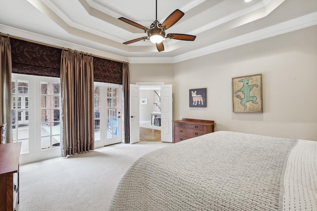 bedroom with access to outside, crown molding, ceiling fan, and a tray ceiling