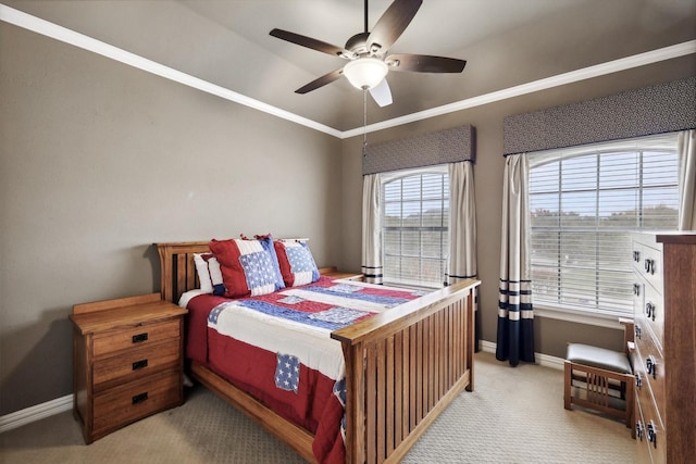 bedroom featuring ceiling fan, crown molding, and light carpet