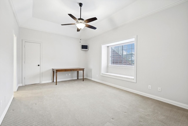 unfurnished room featuring ceiling fan, crown molding, and light carpet