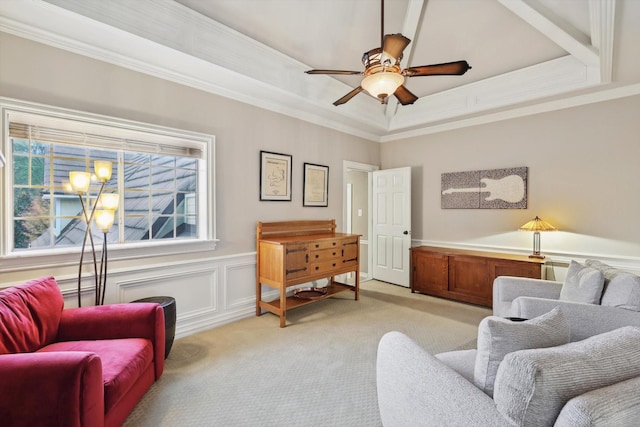 interior space with a raised ceiling, crown molding, ceiling fan, and light colored carpet