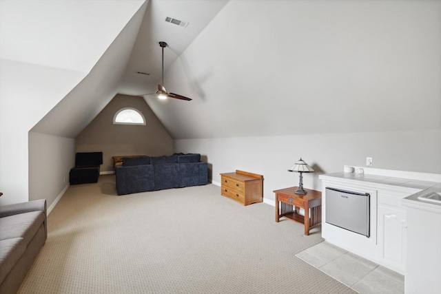 additional living space featuring ceiling fan, light colored carpet, and vaulted ceiling