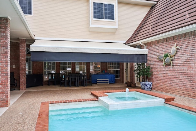 view of swimming pool with a patio area and an in ground hot tub