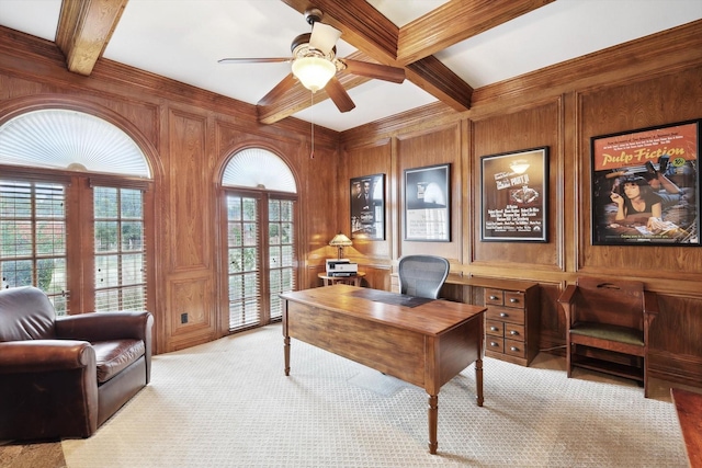 carpeted office featuring wood walls, ceiling fan, a healthy amount of sunlight, and beamed ceiling