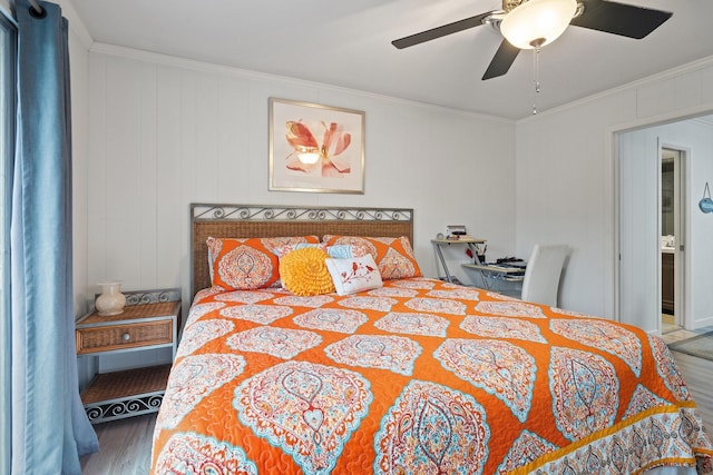 bedroom with ceiling fan, hardwood / wood-style floors, and crown molding