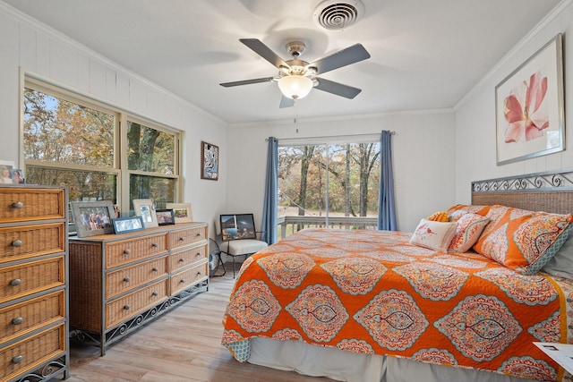 bedroom with ceiling fan, ornamental molding, and light hardwood / wood-style flooring