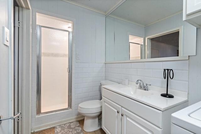 bathroom featuring vanity, toilet, crown molding, and tile walls