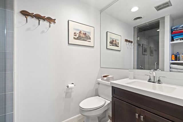 bathroom featuring vanity, an enclosed shower, and toilet