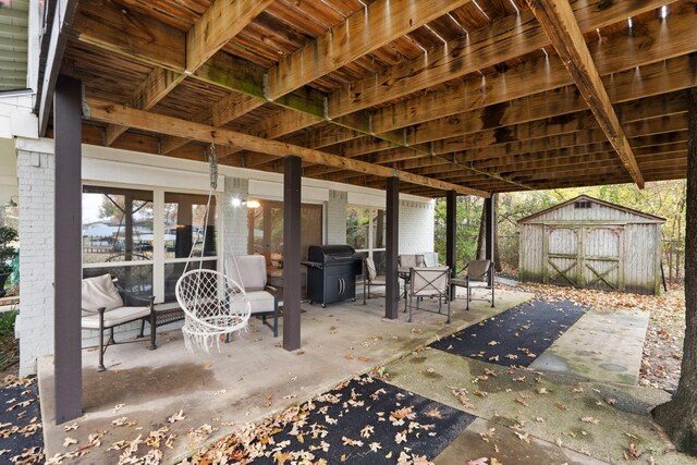 view of patio / terrace with area for grilling and a storage shed