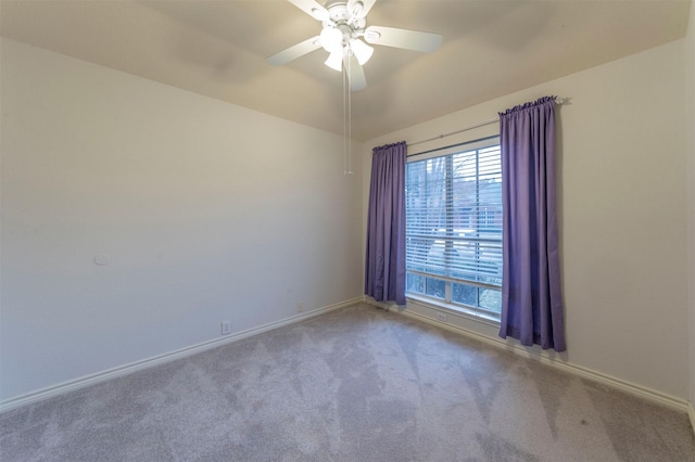 carpeted empty room with vaulted ceiling and ceiling fan