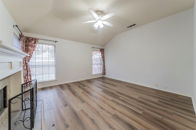 unfurnished living room featuring ceiling fan, lofted ceiling, and hardwood / wood-style floors