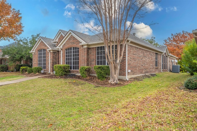 single story home with central AC unit and a front lawn