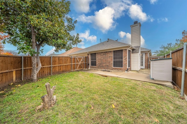 rear view of property with a patio area and a lawn