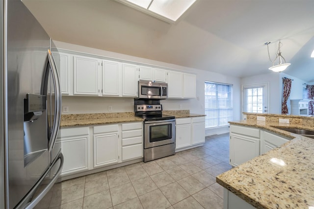 kitchen with light stone counters, hanging light fixtures, stainless steel appliances, and white cabinets