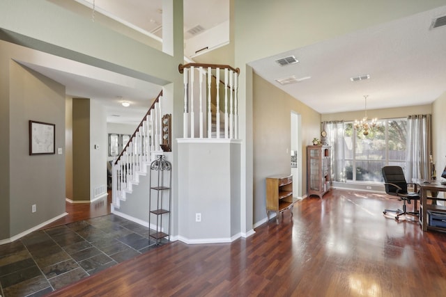 entryway with a chandelier and dark wood-type flooring