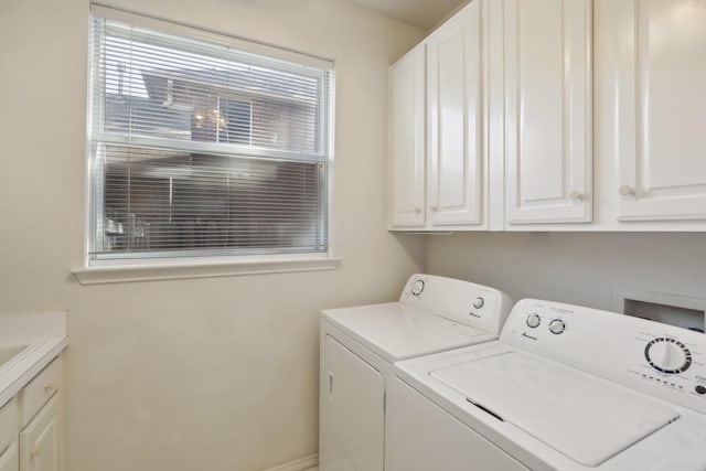 laundry room featuring cabinets and washer and dryer