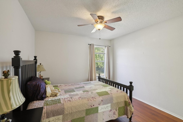 bedroom featuring wood-type flooring, a textured ceiling, and ceiling fan