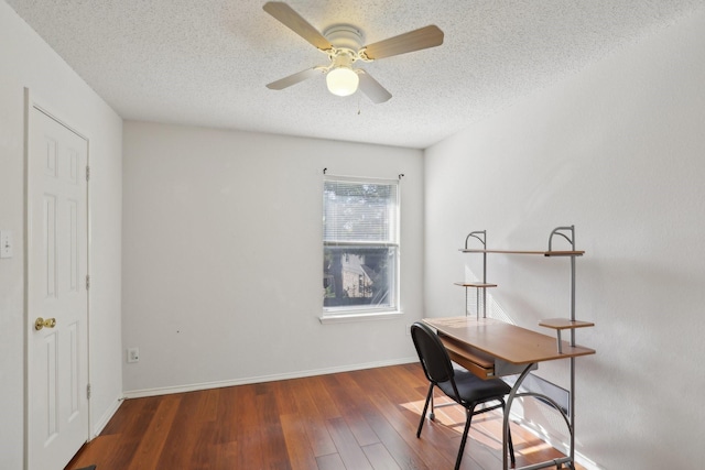 office featuring a textured ceiling, ceiling fan, and dark hardwood / wood-style floors