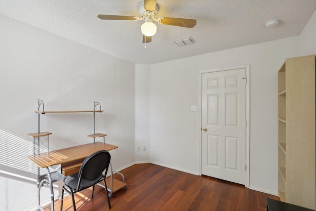 office area with ceiling fan, dark hardwood / wood-style flooring, and a textured ceiling