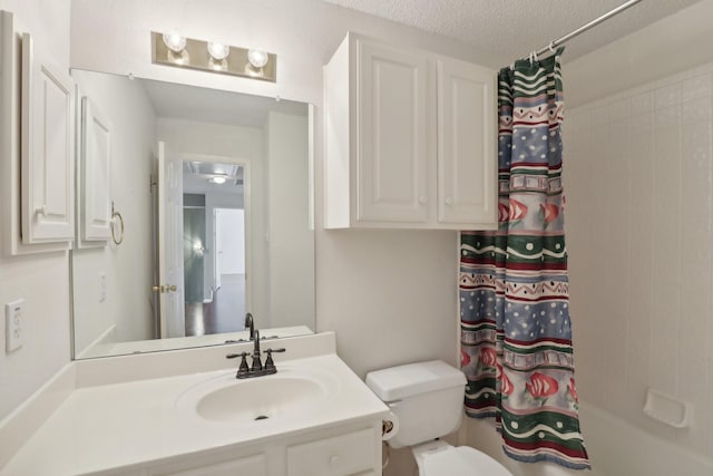 full bathroom featuring vanity, shower / bath combination with curtain, a textured ceiling, and toilet