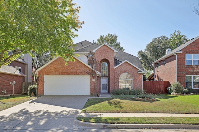 view of property with a garage and a front lawn