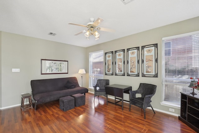 living room featuring ceiling fan and dark hardwood / wood-style floors