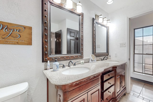 bathroom with tile patterned floors, vanity, and toilet