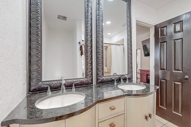 bathroom featuring a shower with curtain, tile patterned floors, and vanity