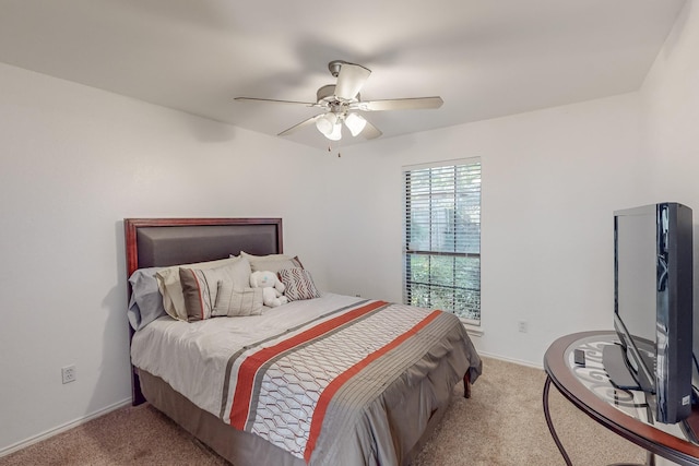 bedroom featuring light colored carpet and ceiling fan