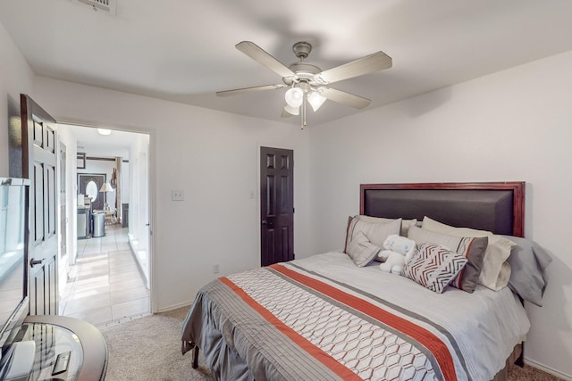 bedroom featuring light colored carpet and ceiling fan