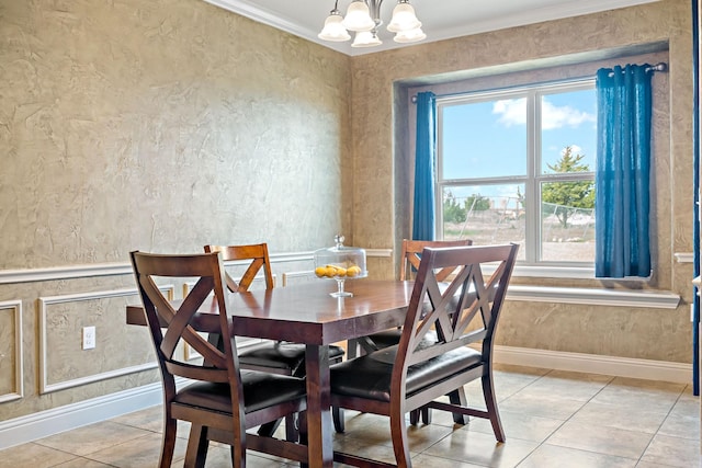 tiled dining room featuring ornamental molding and a chandelier