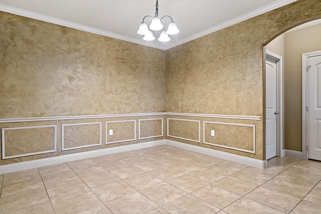 spare room featuring a chandelier and ornamental molding