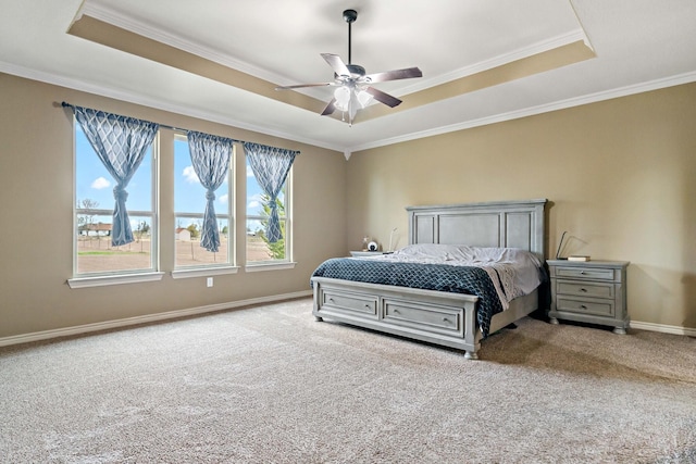 carpeted bedroom with a raised ceiling, ceiling fan, and ornamental molding