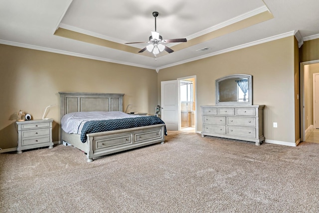 bedroom with ensuite bathroom, a raised ceiling, crown molding, carpet flooring, and ceiling fan