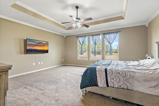 bedroom with light carpet, a tray ceiling, ornamental molding, and ceiling fan