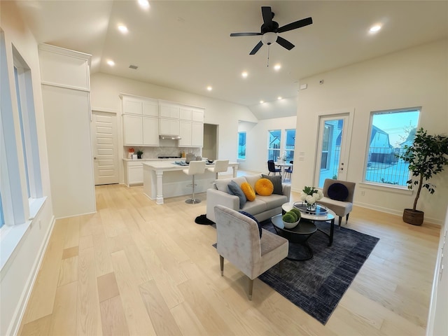 living room featuring ceiling fan and light hardwood / wood-style floors