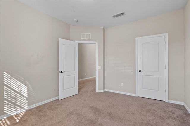 empty room featuring light carpet