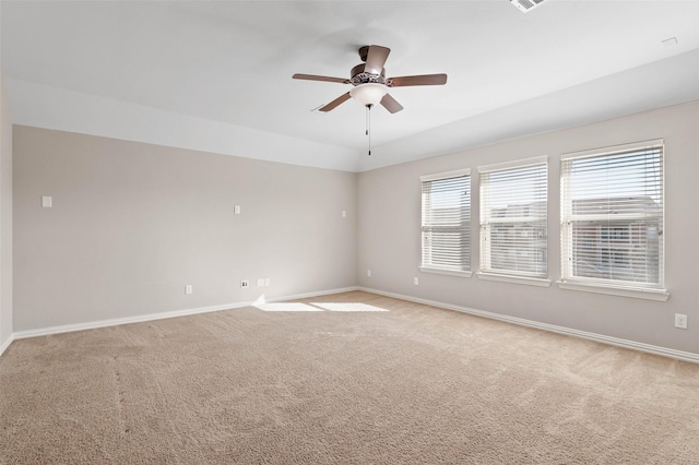 carpeted spare room featuring ceiling fan