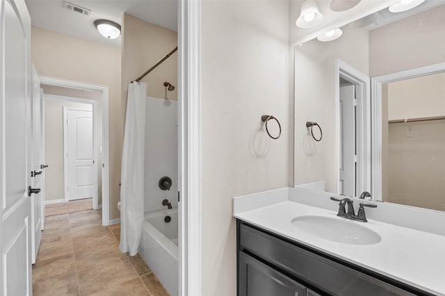 bathroom with shower / bath combo, vanity, and tile patterned floors