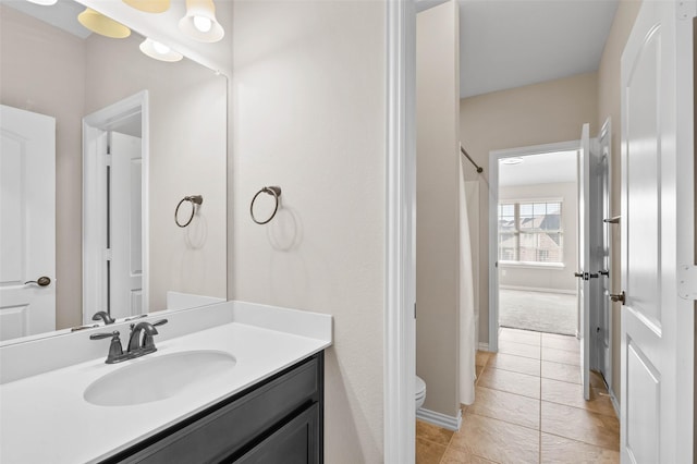 bathroom with vanity, tile patterned floors, and toilet