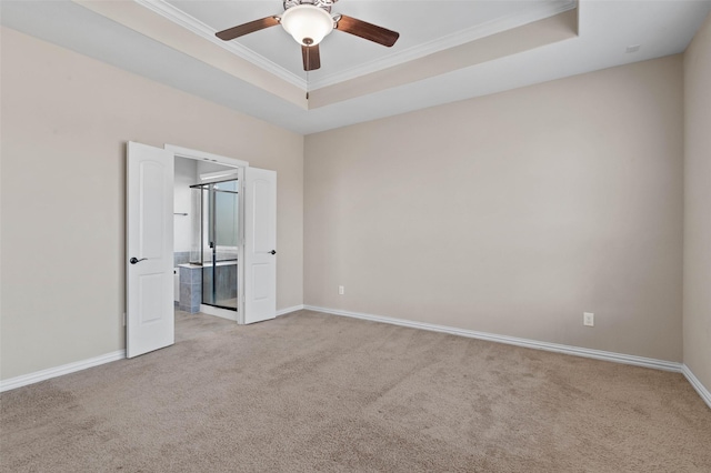 unfurnished bedroom featuring crown molding, light colored carpet, a raised ceiling, and ceiling fan